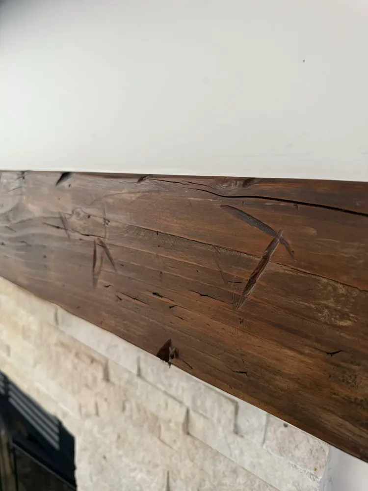 Hand-finished distressed wood mantel with a custom decorative treatment by Piñon Painting