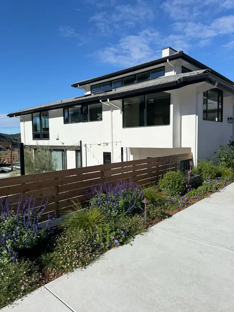 Modern coastal home with white stucco and dark trim near Shell Beach, CA